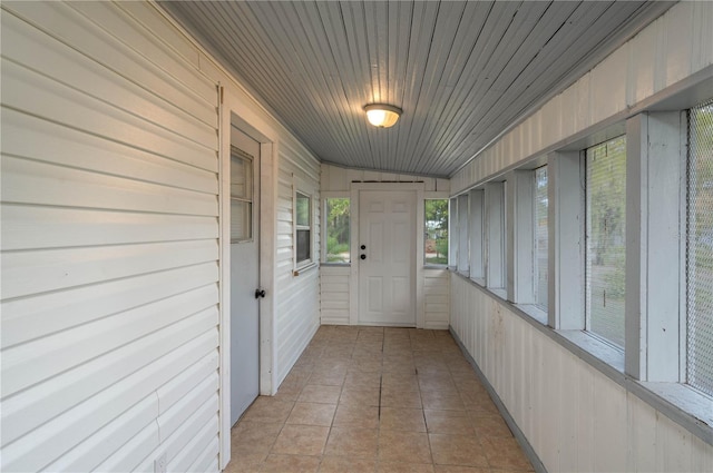 unfurnished sunroom featuring lofted ceiling