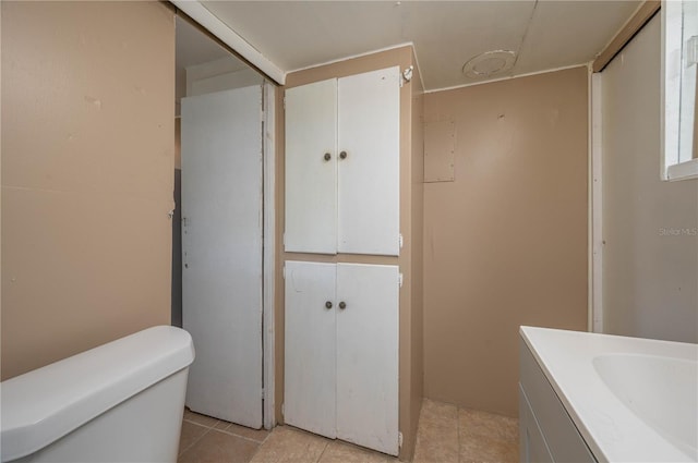 bathroom featuring vanity, tile patterned floors, and toilet