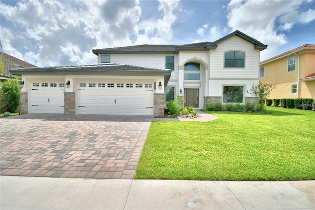 view of front of home featuring a garage and a front yard