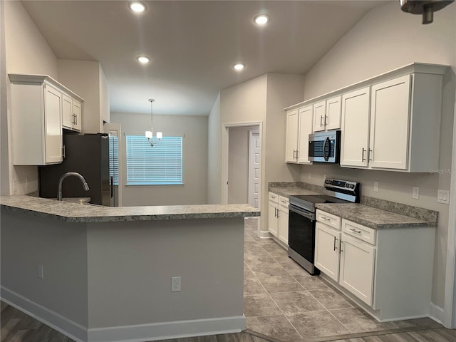 kitchen featuring kitchen peninsula, appliances with stainless steel finishes, pendant lighting, a chandelier, and white cabinetry