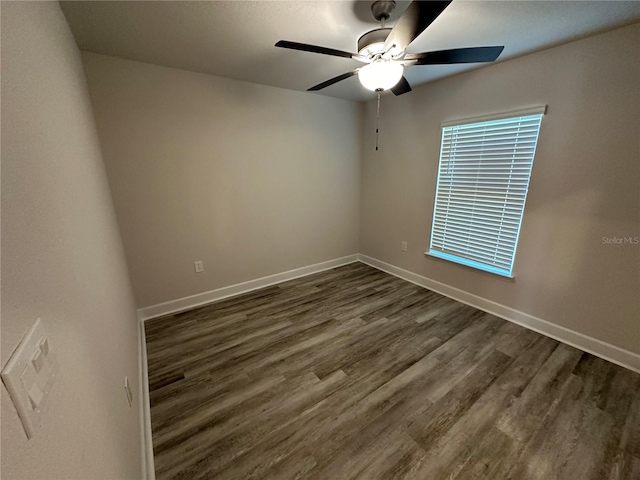 unfurnished room featuring ceiling fan and dark wood-type flooring