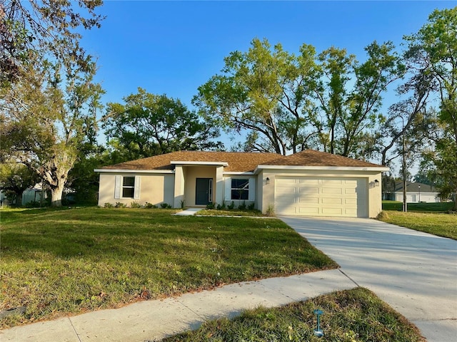 view of front of house featuring a garage, concrete driveway, a front lawn, and stucco siding