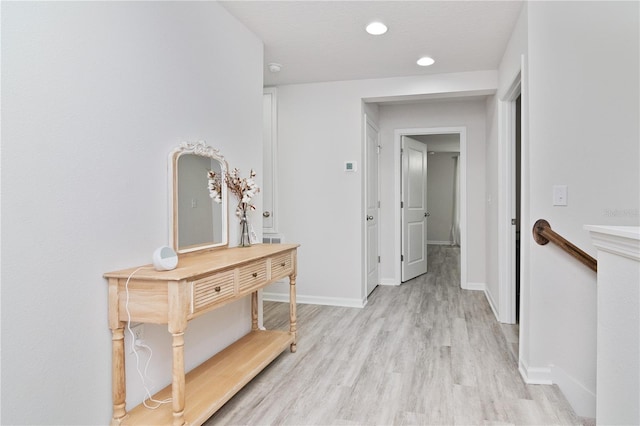 corridor with light hardwood / wood-style flooring