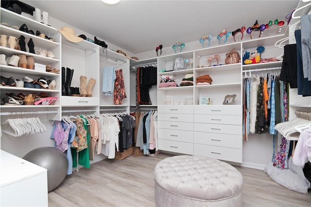 walk in closet featuring light hardwood / wood-style flooring