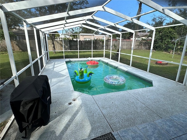 view of pool with glass enclosure, grilling area, a yard, and a patio