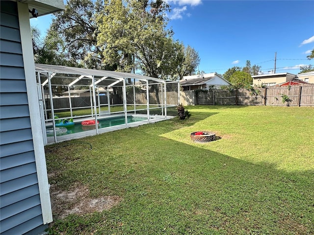 view of yard with a fenced in pool and a lanai