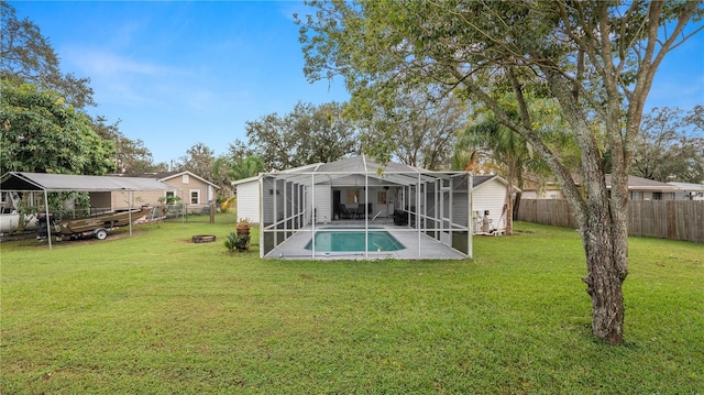 rear view of house featuring a yard, a patio, a fenced in pool, and glass enclosure