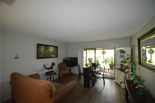 living room with hardwood / wood-style flooring and a textured ceiling