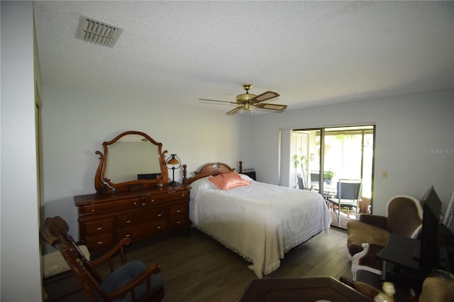 bedroom featuring a textured ceiling, access to outside, ceiling fan, and dark hardwood / wood-style floors