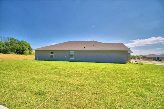 view of side of home featuring a yard