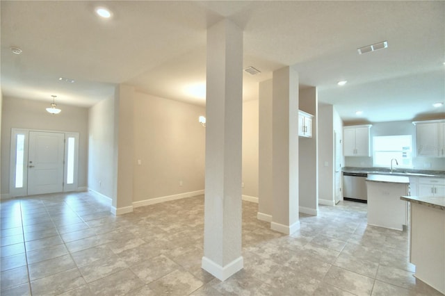 interior space featuring light tile patterned floors and sink