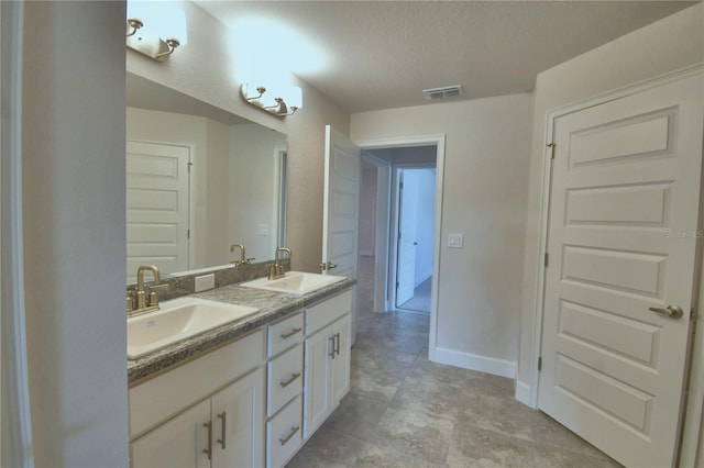 bathroom featuring vanity and a textured ceiling