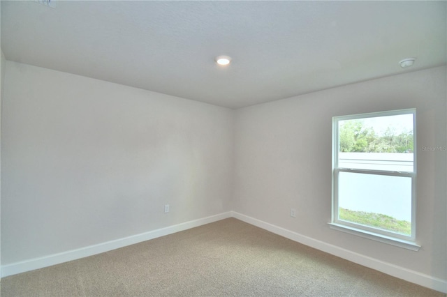 carpeted empty room with plenty of natural light