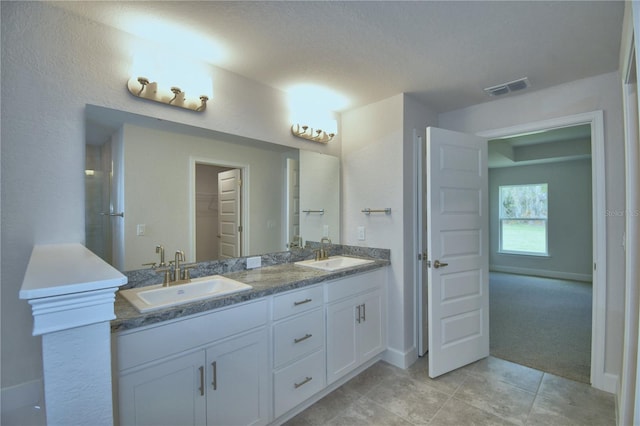 bathroom featuring vanity, a textured ceiling, and tile patterned floors