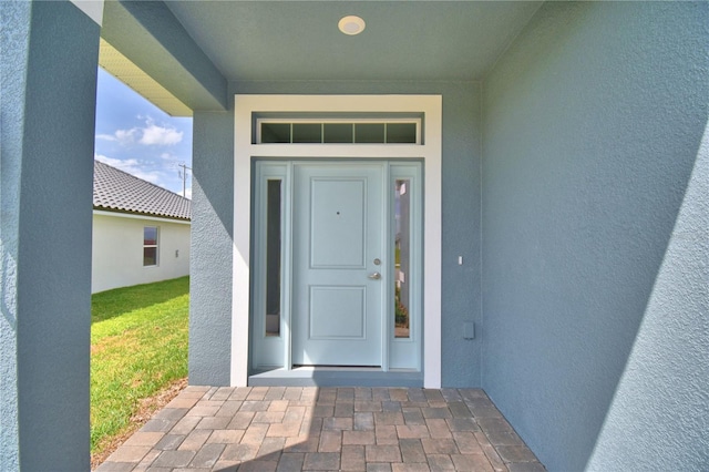 property entrance featuring stucco siding