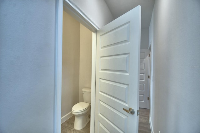 bathroom featuring toilet and baseboards