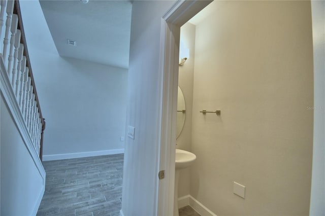 bathroom with baseboards and wood finished floors
