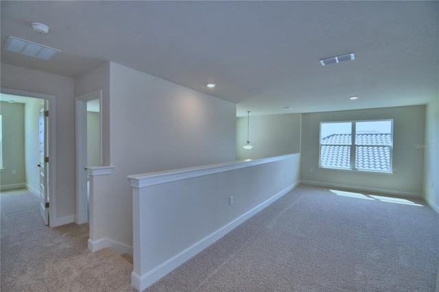 carpeted empty room featuring recessed lighting, visible vents, and baseboards