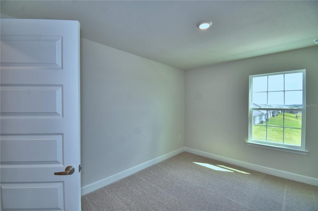 empty room with carpet floors and baseboards