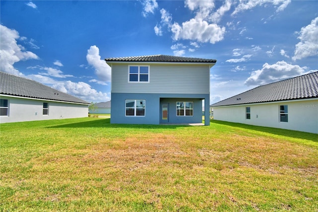 back of house with a lawn