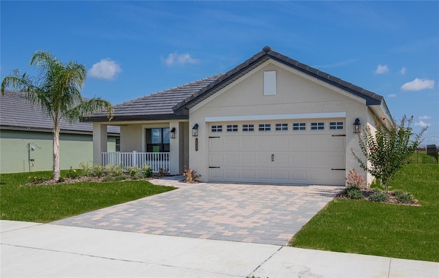 single story home featuring a garage, a front yard, and covered porch