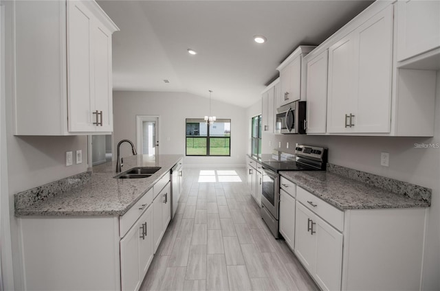 kitchen featuring white cabinetry, appliances with stainless steel finishes, lofted ceiling, and sink