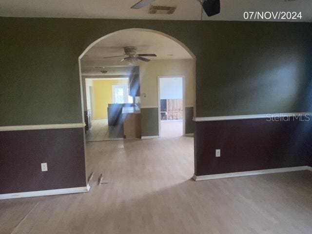 spare room with hardwood / wood-style flooring and ceiling fan