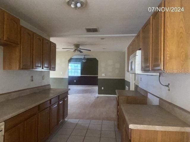 kitchen featuring ceiling fan and light tile patterned floors