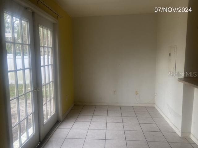 tiled spare room with french doors