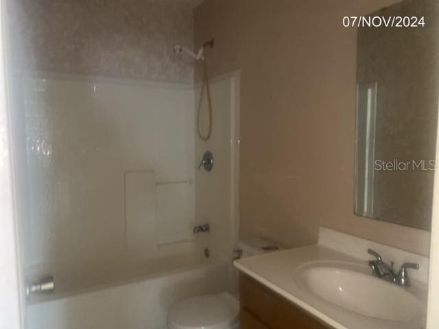 full bathroom featuring vanity, shower / bathtub combination, and toilet