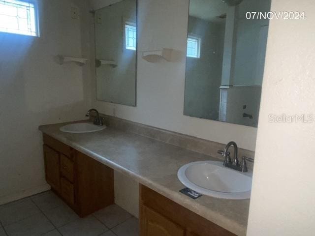 bathroom with tile patterned flooring and vanity