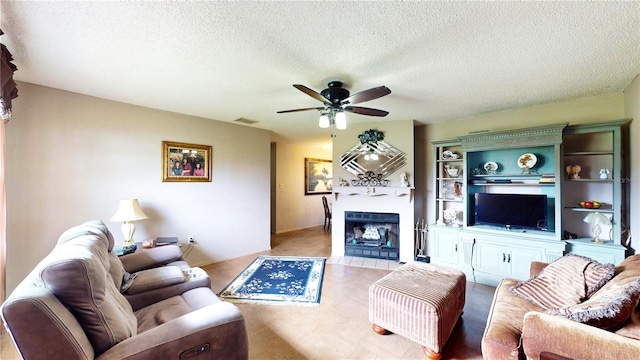 living room featuring a textured ceiling and ceiling fan