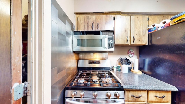 kitchen featuring decorative backsplash and appliances with stainless steel finishes