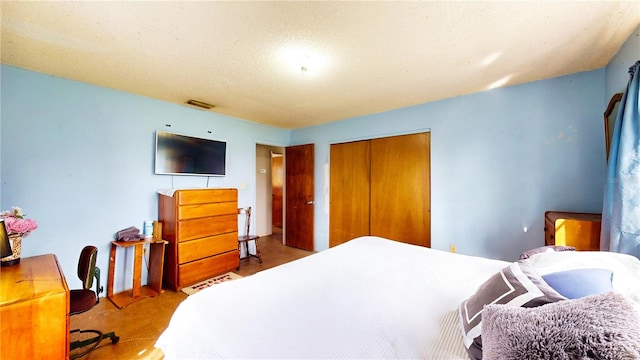 bedroom featuring a textured ceiling and a closet