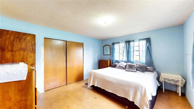 bedroom featuring light wood-type flooring and a textured ceiling