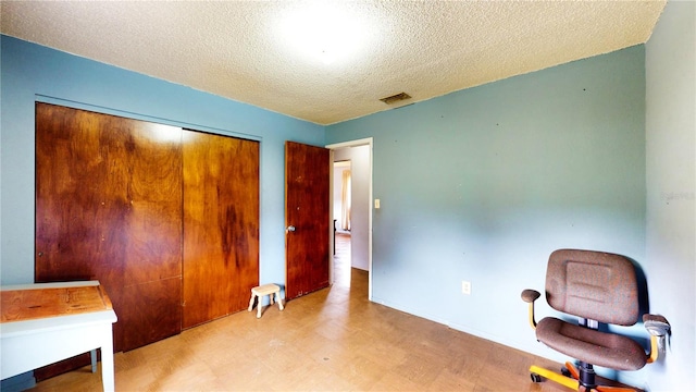 office space with a textured ceiling