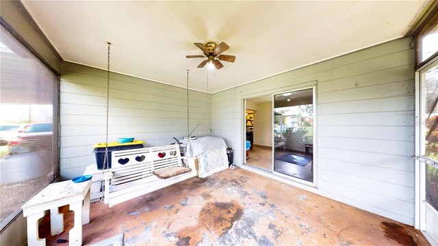 sunroom featuring ceiling fan and a healthy amount of sunlight