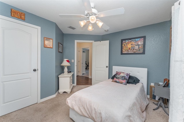 carpeted bedroom with ceiling fan