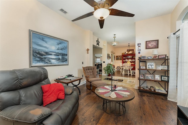 living room featuring ceiling fan and dark hardwood / wood-style flooring