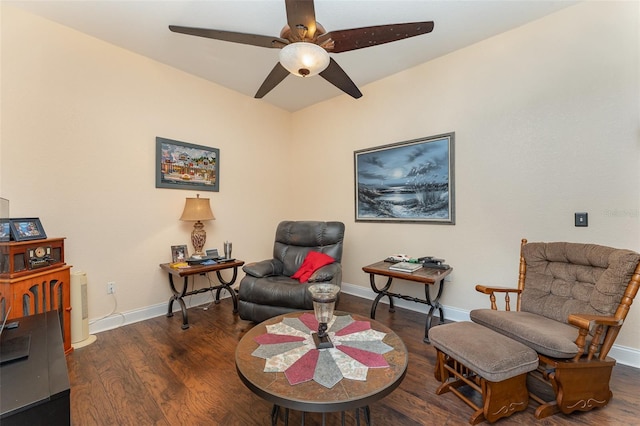 living area featuring ceiling fan and dark hardwood / wood-style floors