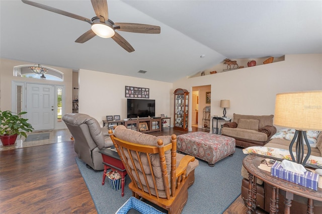 living room featuring ceiling fan, vaulted ceiling, and dark wood-type flooring