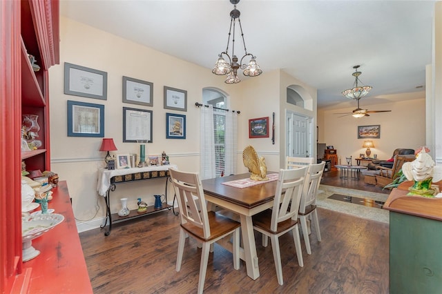 dining area featuring dark wood-type flooring and ceiling fan with notable chandelier