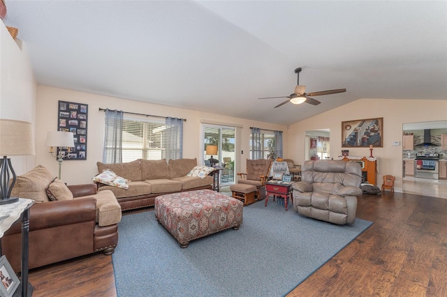 living room featuring ceiling fan, vaulted ceiling, and dark hardwood / wood-style floors