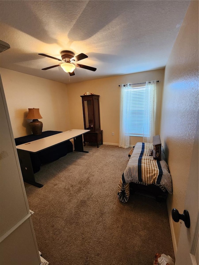 carpeted bedroom featuring ceiling fan and a textured ceiling