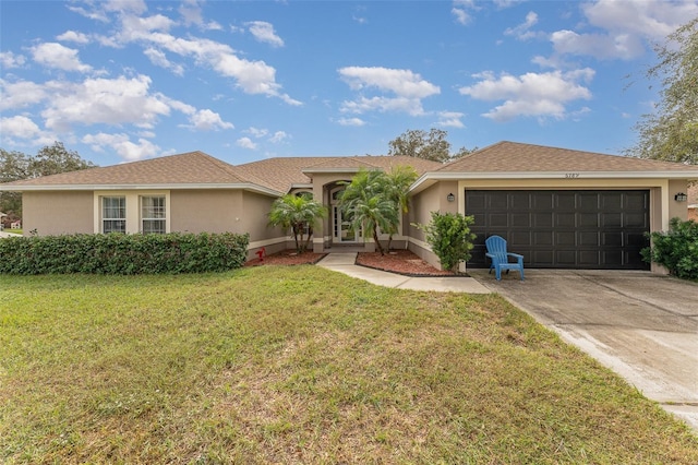 view of front of house with a front lawn and a garage