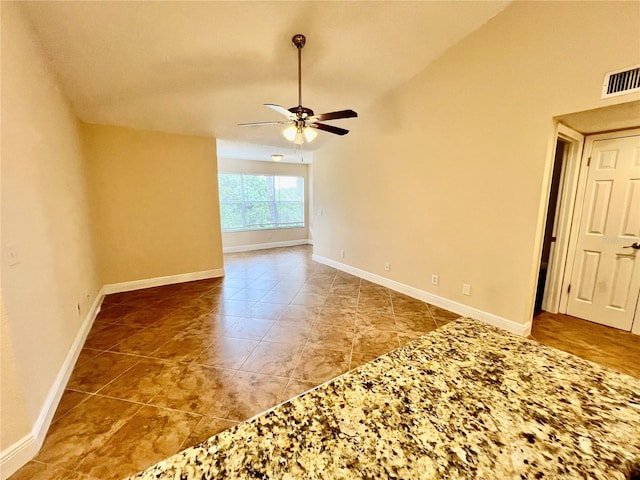 spare room featuring ceiling fan and vaulted ceiling