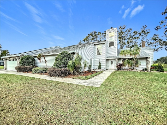 view of front of property with a garage and a front yard