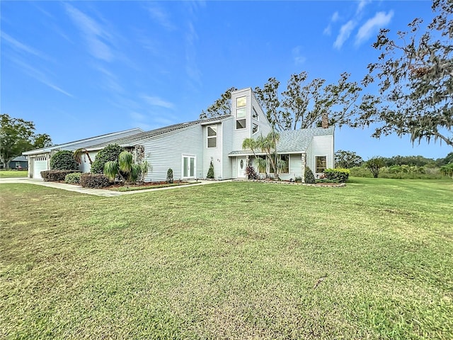 view of front facade with a front lawn and a garage