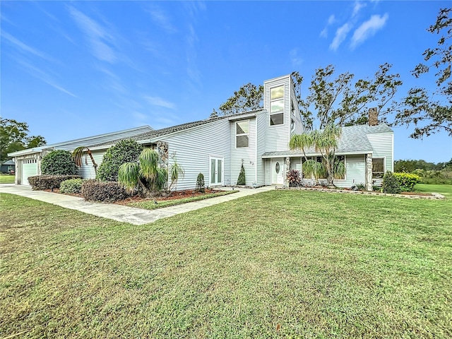 view of front of house with a front yard and a garage