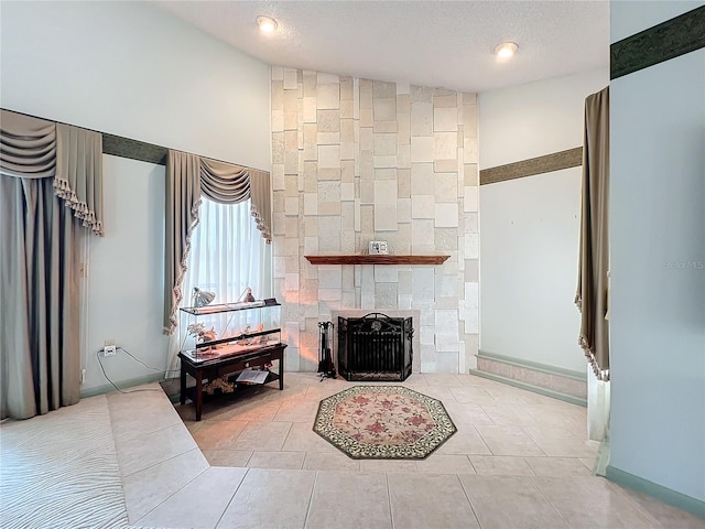 tiled living room with a stone fireplace, lofted ceiling, and a textured ceiling